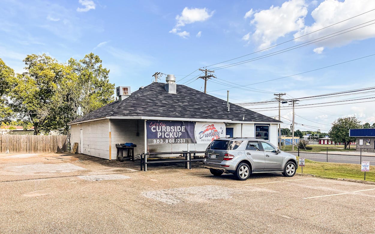 A customer waits inside their vehicle for curbside pickup at Dudley's Grab & Geaux in Longview on August 13, 2021. After closing in November because of losses caused by the pandemic, the cajun café reopened this summer in the form of a to-go kitchen.
