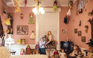 Jeromy Jones’s daughter Makenna Grace Erler surrounded by a collection of creepy dolls in room 14. 