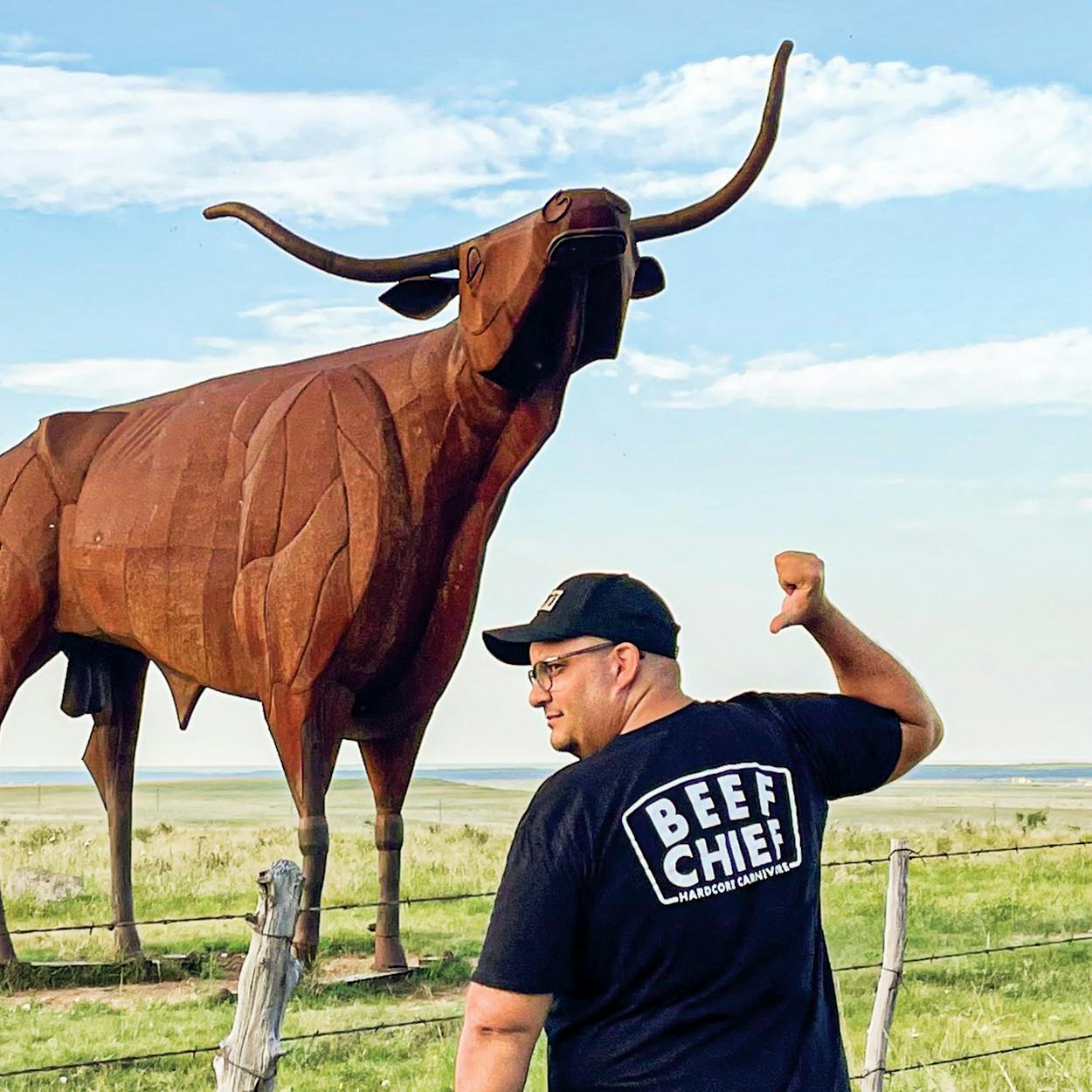 Daniel Vaughn in front of the 22-foot-tall Bridle Bit Bull sculpture, about 10 miles west of Throckmorton.