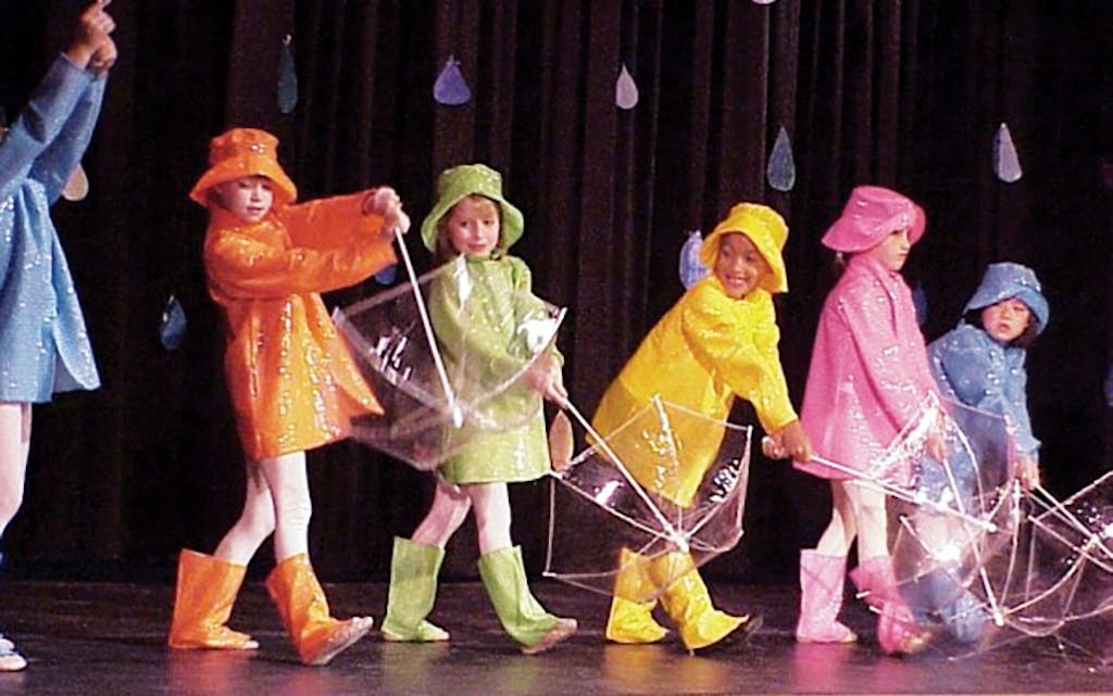 Watters (in yellow) at a dance recital circa 1999.