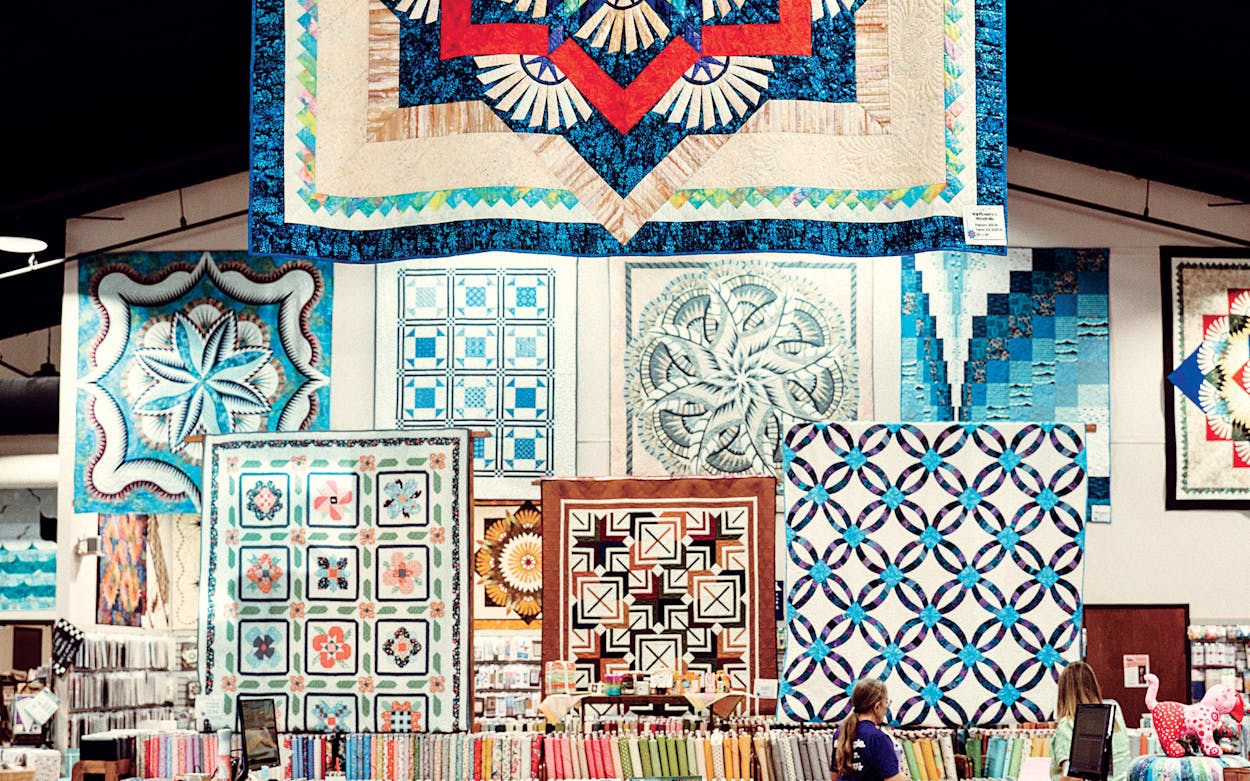 Quilts hanging at Stitchin’ Heaven, in Quitman.
