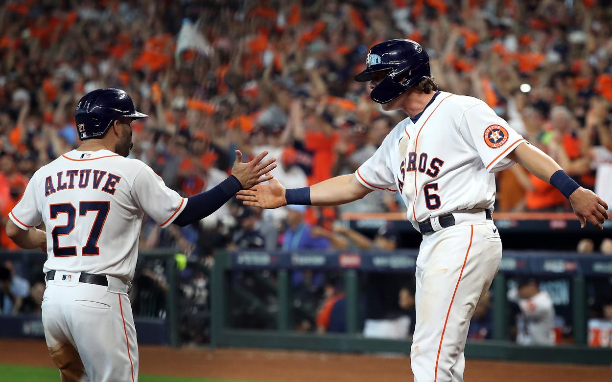 HOUSTON, TEXAS - OCTOBER 07: Jake Meyers #6 and Jose Altuve #27 of the Houston Astros congratulate each other at home plate after scoring during the 4th inning of Game 1 of the American League Division Series against the Chicago White Sox at Minute Maid Park on October 07, 2021 in Houston, Texas.