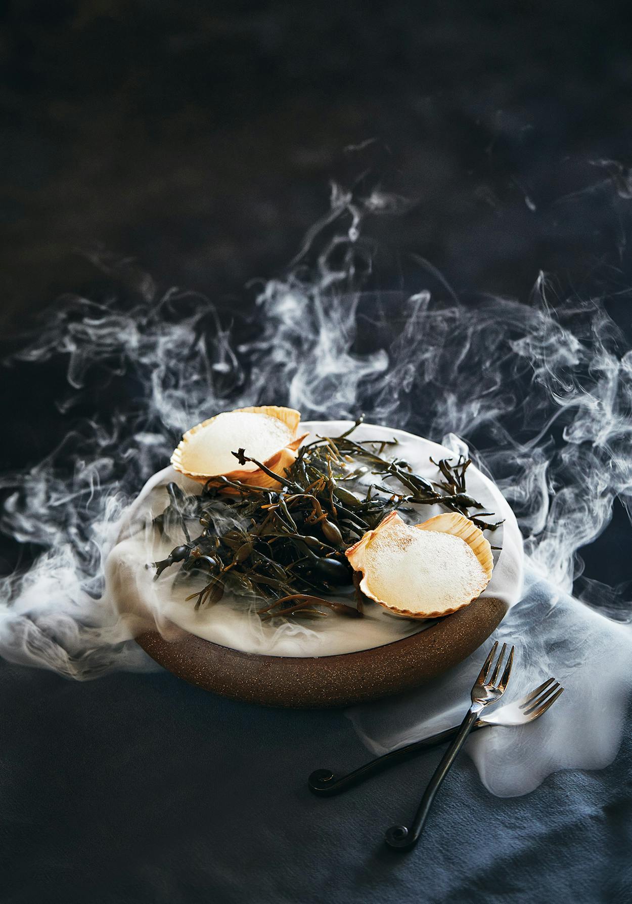 Butter-poached bay scallops served over seaweed and dry ice.