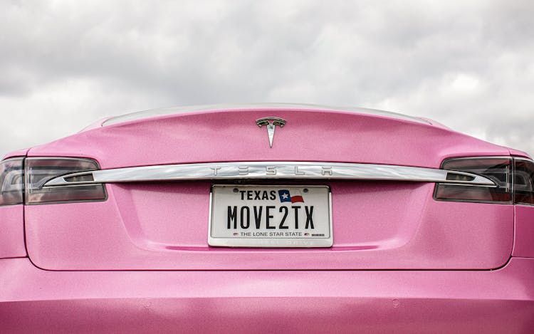 Bailey's pink Tesla, with license plates that read “MOVE2TX.”