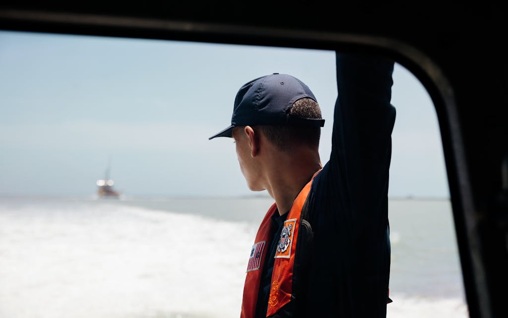 A U.S. Coast Guard keeps an eye on a boat behind them in South Padre Island on June 9, 2021.