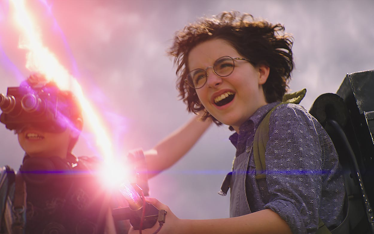 Still from the new 'Ghostbusters' of McKenna Grace shooting a red beam out of a proton pack.