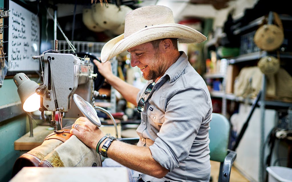 Hansler repairing a saddle bag at his leather workshop near Runge.