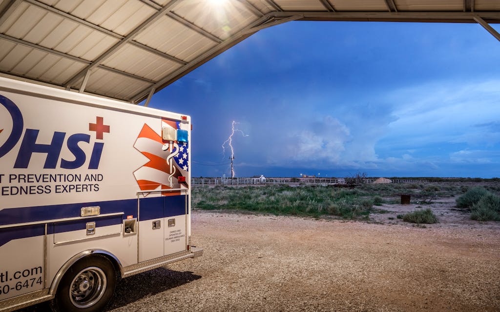 Lightning wraps around a telephone pole in the distance, seen from the OHSI ambulance dock in July 2021.