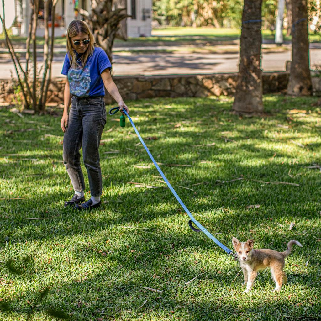 The author with a leashed Augie in her front yard in San Marcos on adoption day: October 28, 2021.
