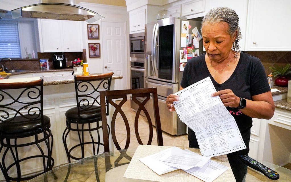 Pam Gaskin opens her mail-in primary election ballot, after multiple requests were rejected earlier this year, at her home Monday, Jan. 31, 2022, in Missouri City.