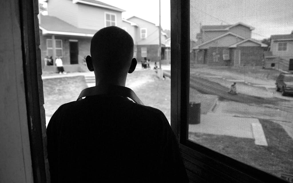 Christian in the doorway of his home, at the Booker T. Washington Terraces housing project, on April 16, 2009.