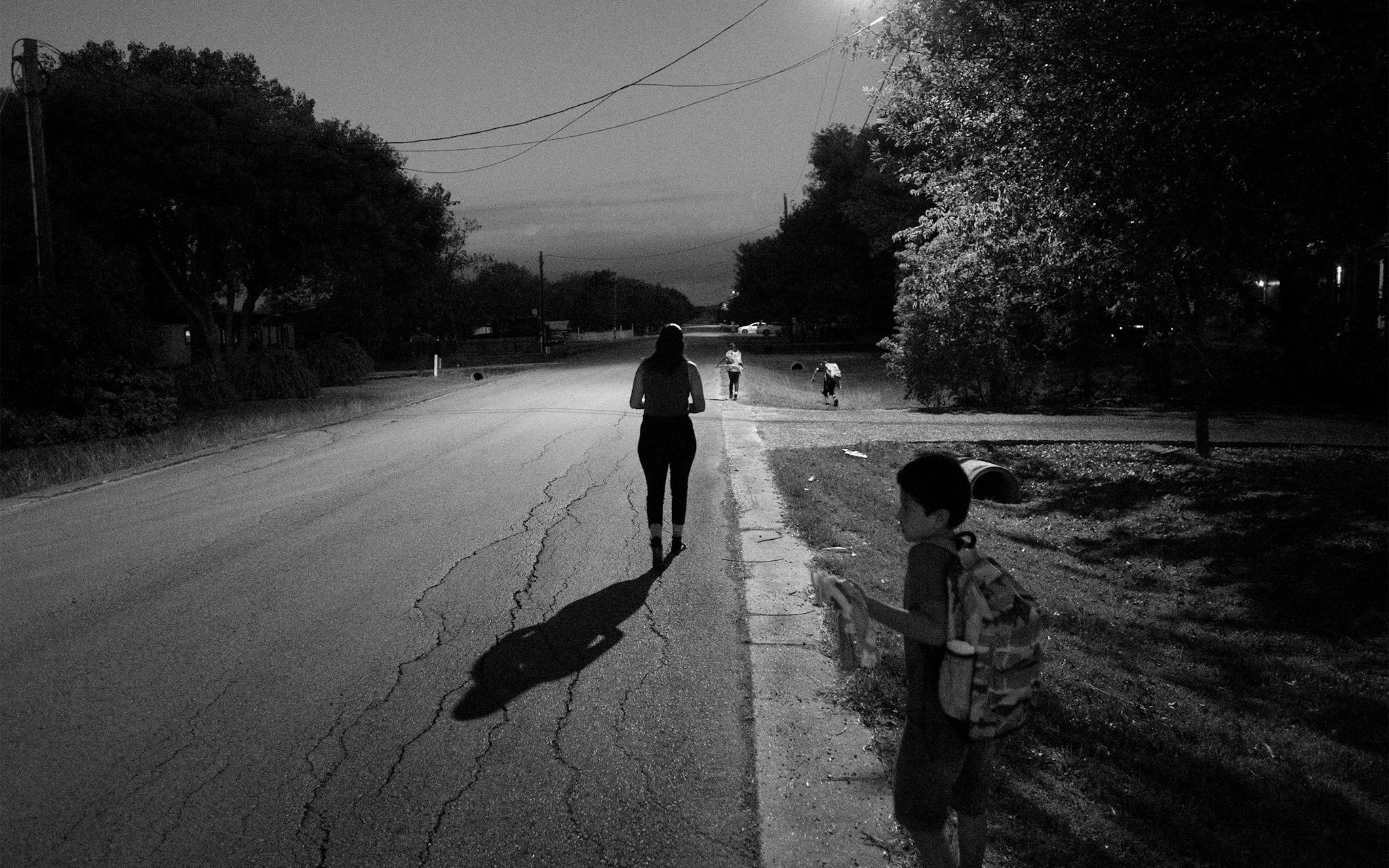 Arleen Juarez, Christian’s oldest sister, walks with her children, Diomani and Hailee Rivera, and her nephew, Dan Estrada, to the school bus pick-up before dawn in Kyle on September 27, 2019.