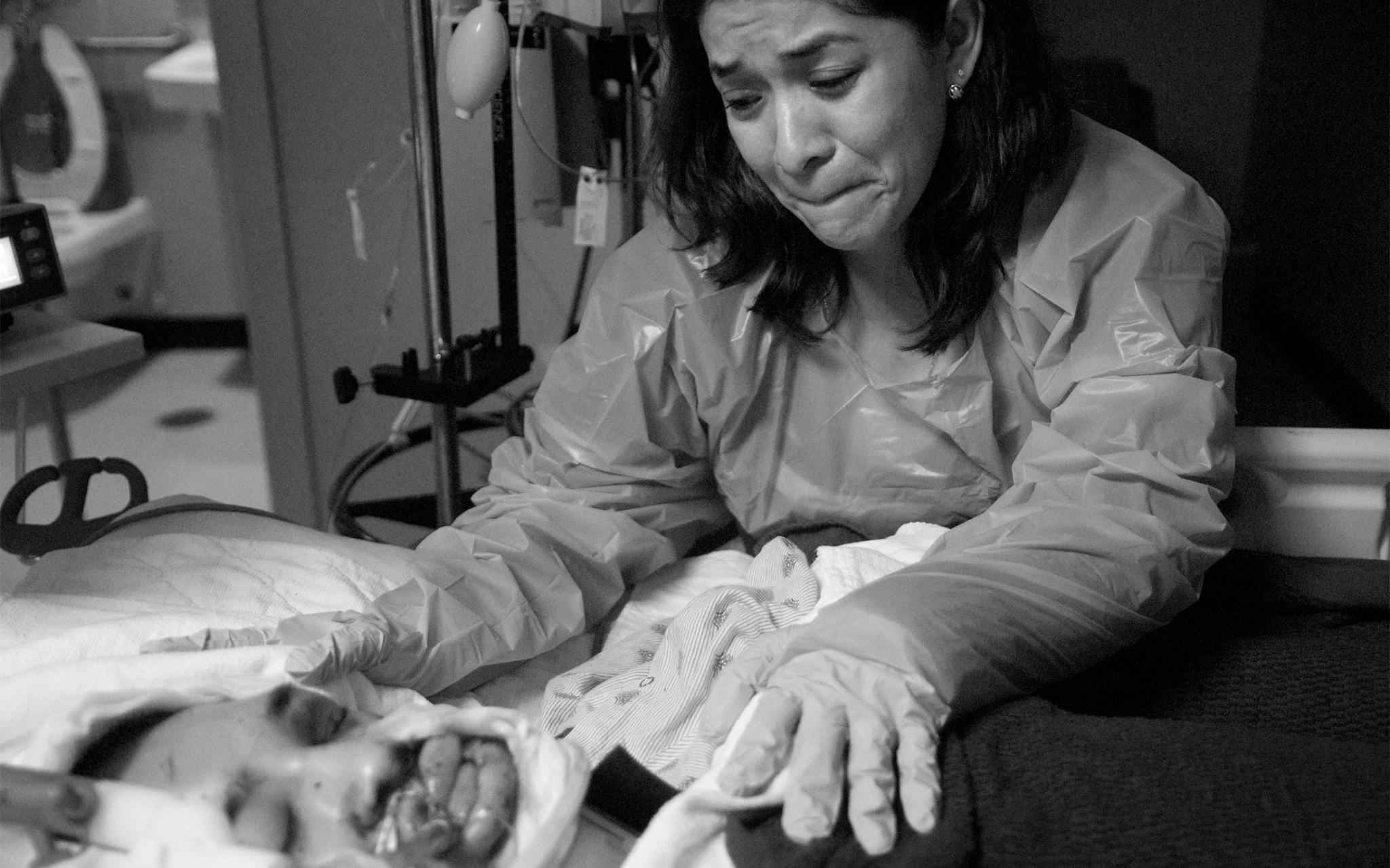 Maricela leans over Christian as he lies in a hospital bed after the fatal accident at Memorial Hermann Hospital in Houston on April 11, 2010.