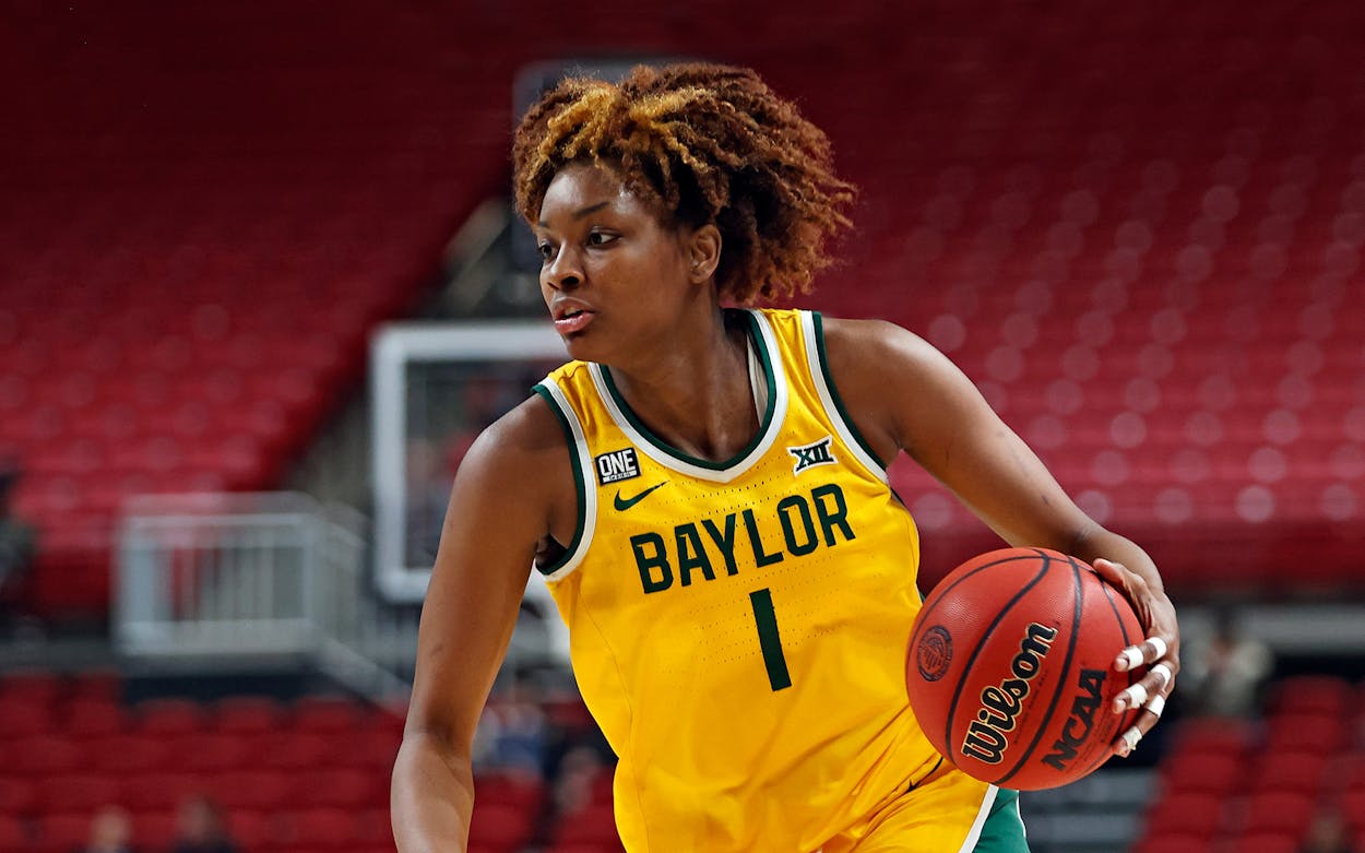 Baylor's NaLyssa Smith dribbles the ball during the second half of an NCAA college basketball game against Texas Tech.