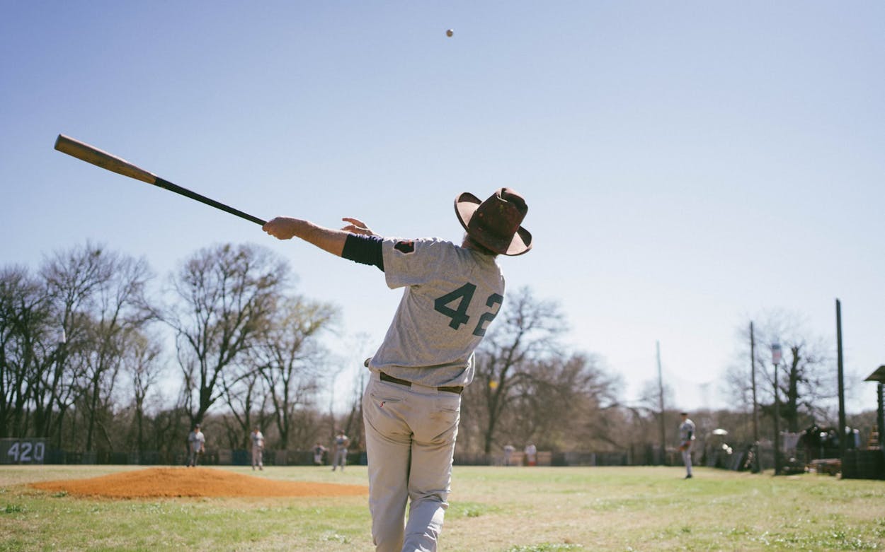 Texas Playboys baseball player swings bat.