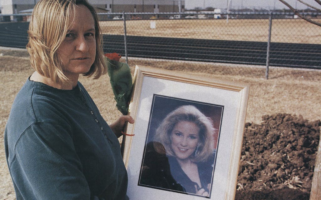 Adrianne Jones' mother, Linda, holding her daughter's portrait at the murder scene. 