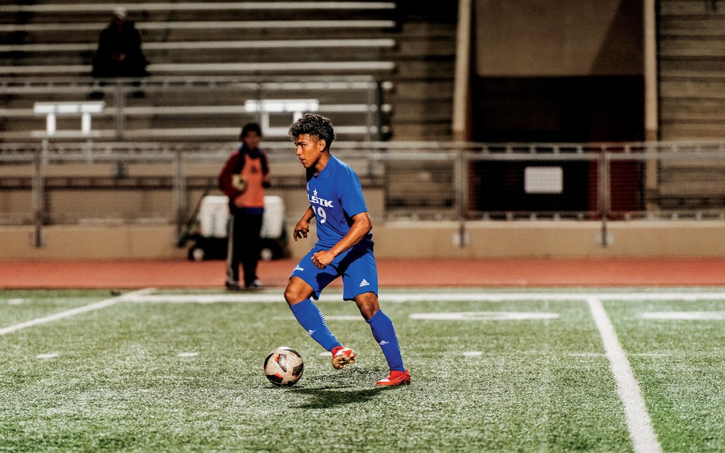 Hector Rodriguez dribbling the ball during a soccer game against Shadow Creek
