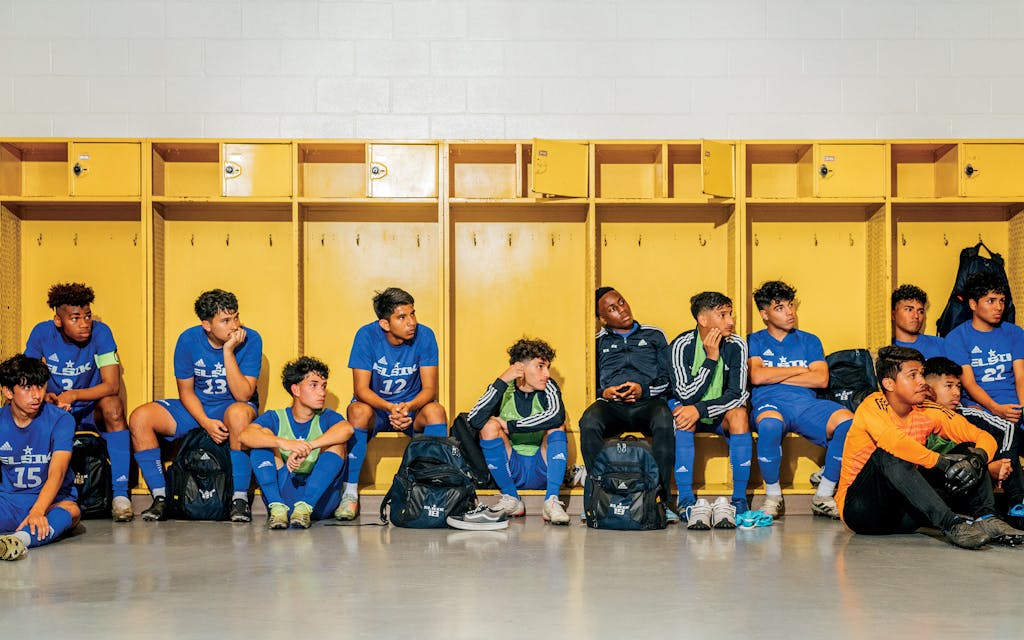 Elsik soccer players listening to a halftime speech from Cox.
