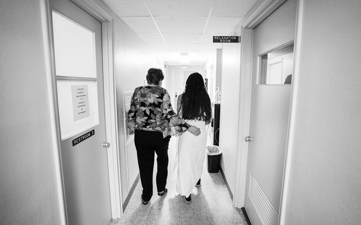 A 33-year-old mother of three from central Texas is escorted down the hall prior to getting an abortion on Oct. 9, 2021, in Shreveport, La.