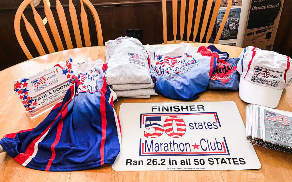 Once confirmation of all 50 states is received, the club sends the runner an acrylic trophy and a 50 States Marathon Club t-shirt. 