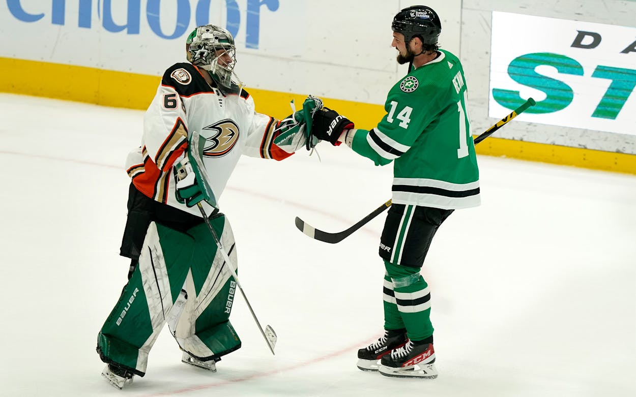 Dallas Stars left wing Jamie Benn (14) and Anaheim Ducks goalie Tom Hodges (86) greet each other at the end of the third period of an NHL hockey game in Dallas, Friday, April 29, 2022. The Stars won 4-2.