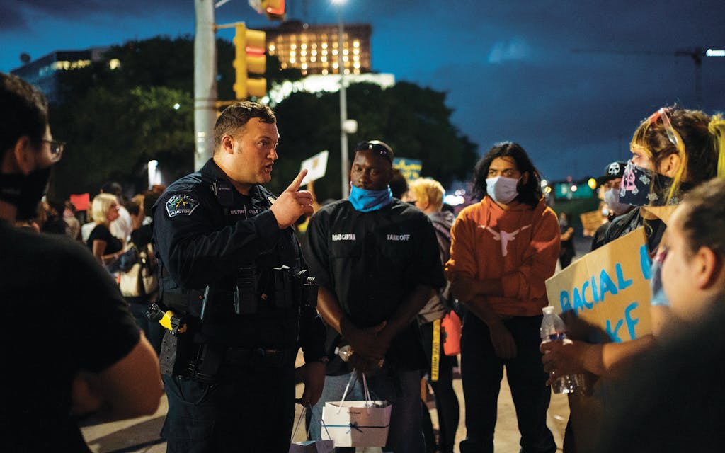 Austin Police officer Justin Berry talks to protesters in front of APD Headquarters on June 2, 2020. Thousands of protesters gathered outside APD Headquarters to protest the murder of George Floyd the hands of police.