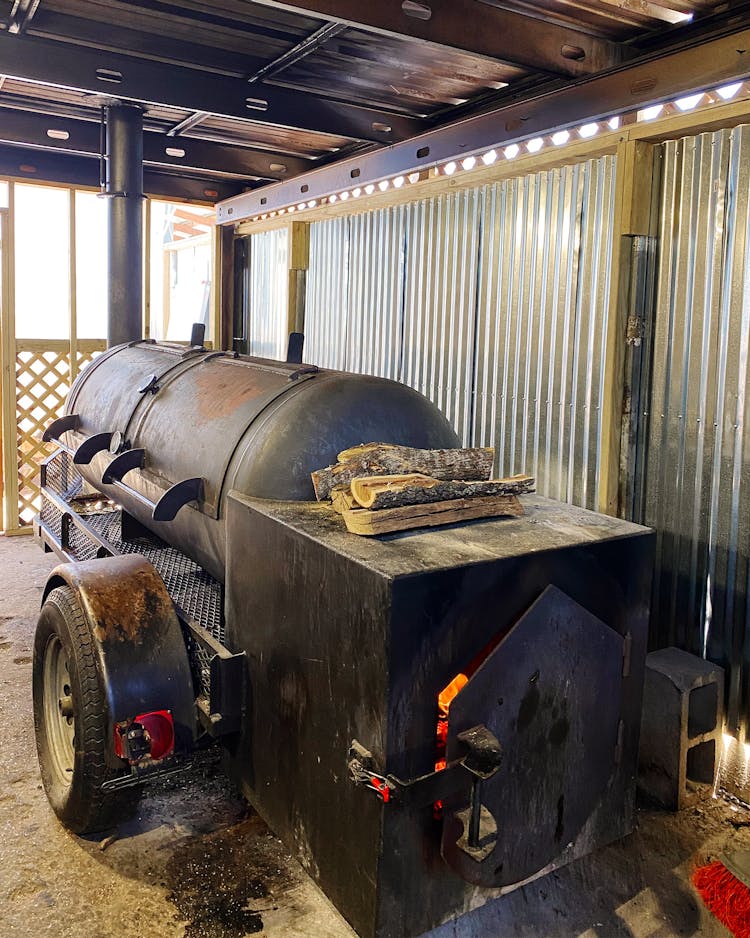 The steel offset smoker in the pit room.