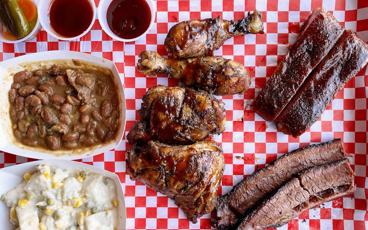 Smoked meats, sides, and Trini pepper sauce from Meshack's BBQ in Plano.