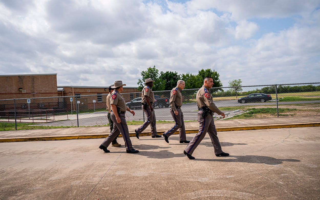 Texas Department of Public Safety Director Steven McCraw, second from right, walks outside Robb Elementary School in Uvalde on Monday, May 30, 2022.