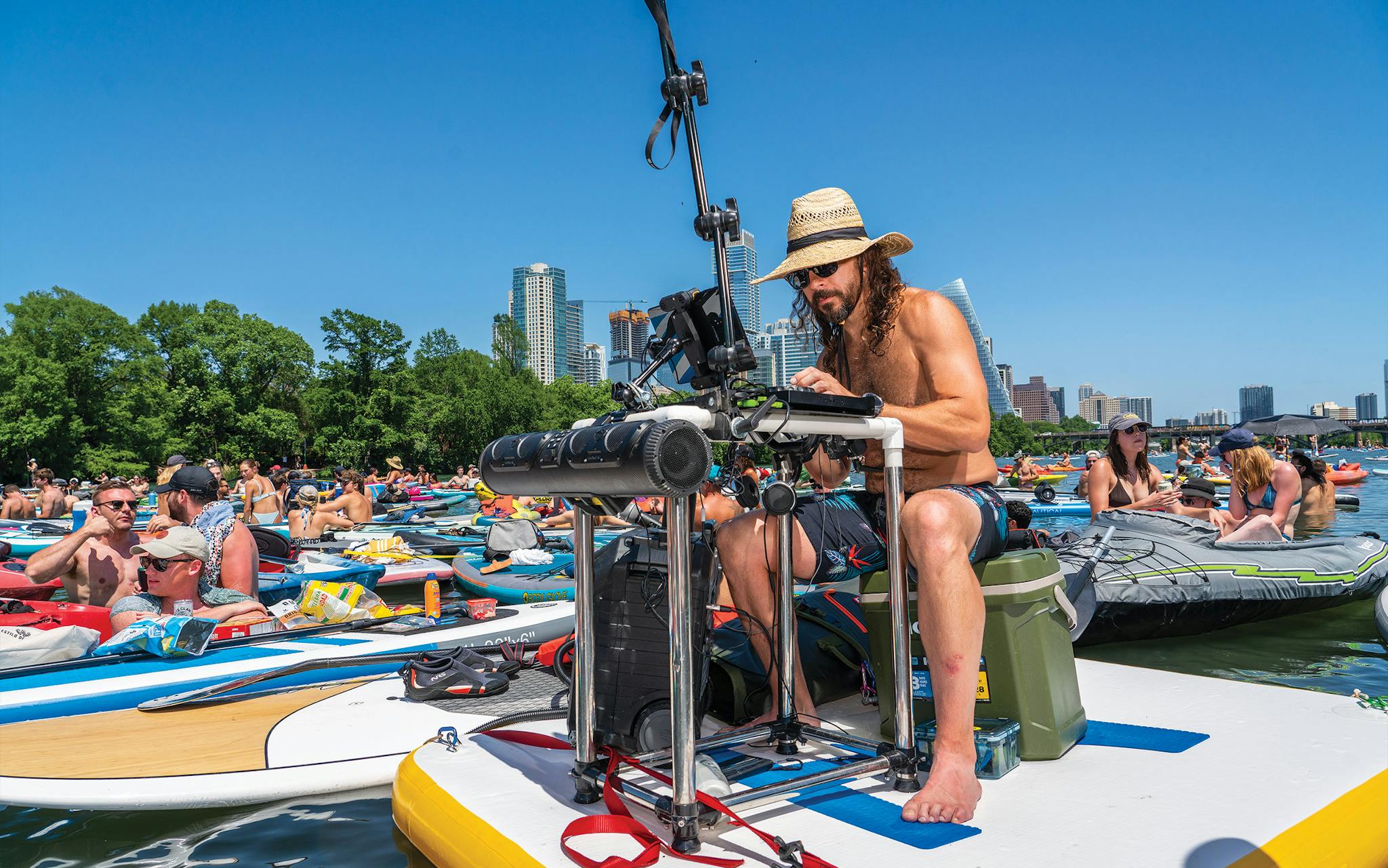 Dustin McInvale deejaying atop a large paddleboard.
