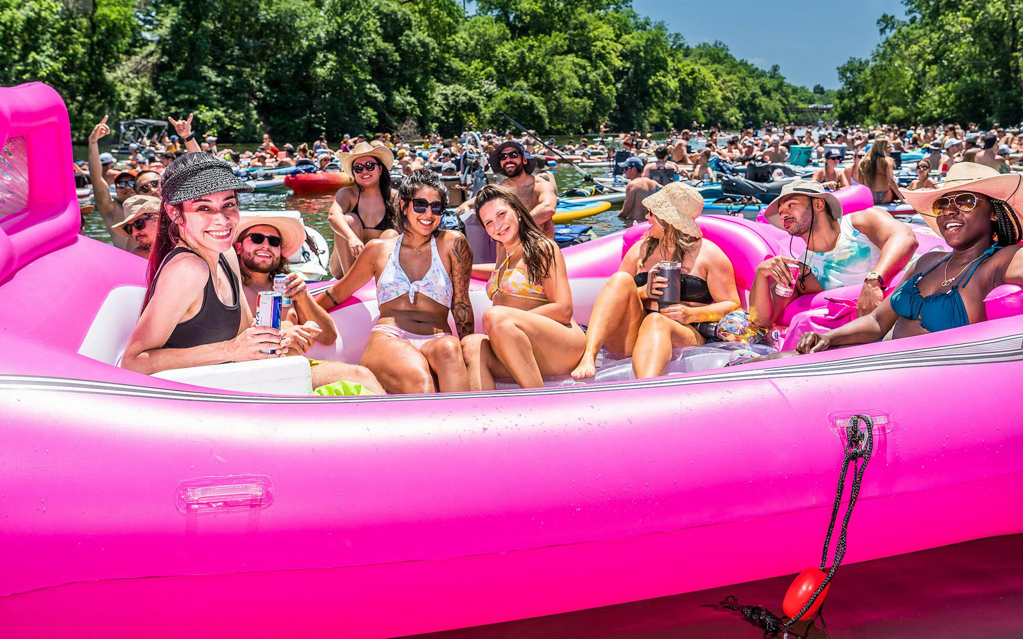 Lake goers in a large pink float.