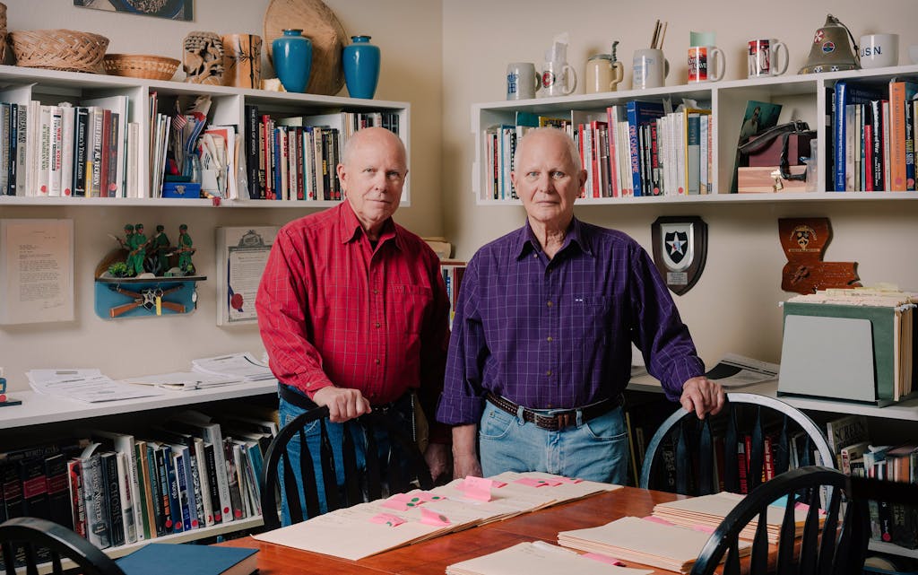 Hal (left) and Ted Barker at home in Dallas, with their book of names.
