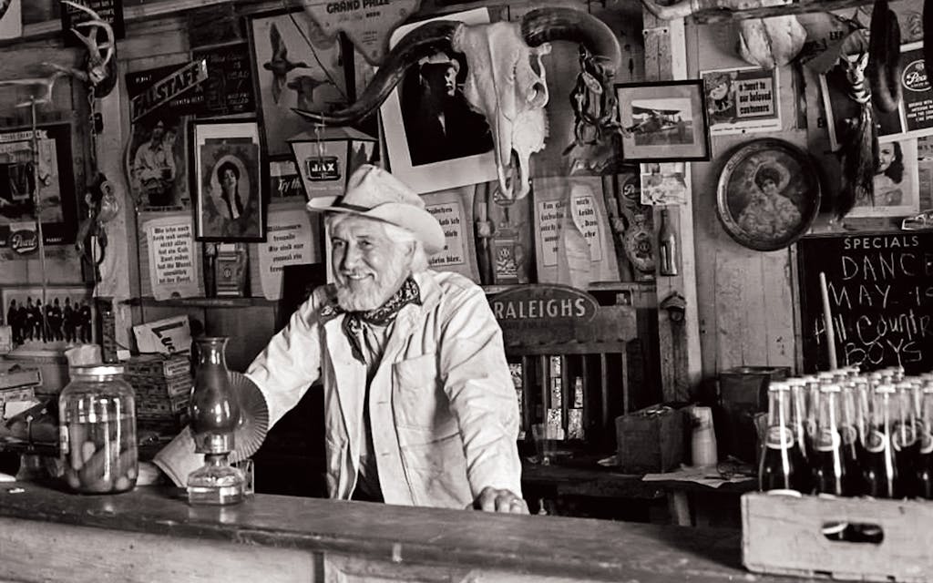 Hondo Crouch behind the Luckenbach bar around 1973.