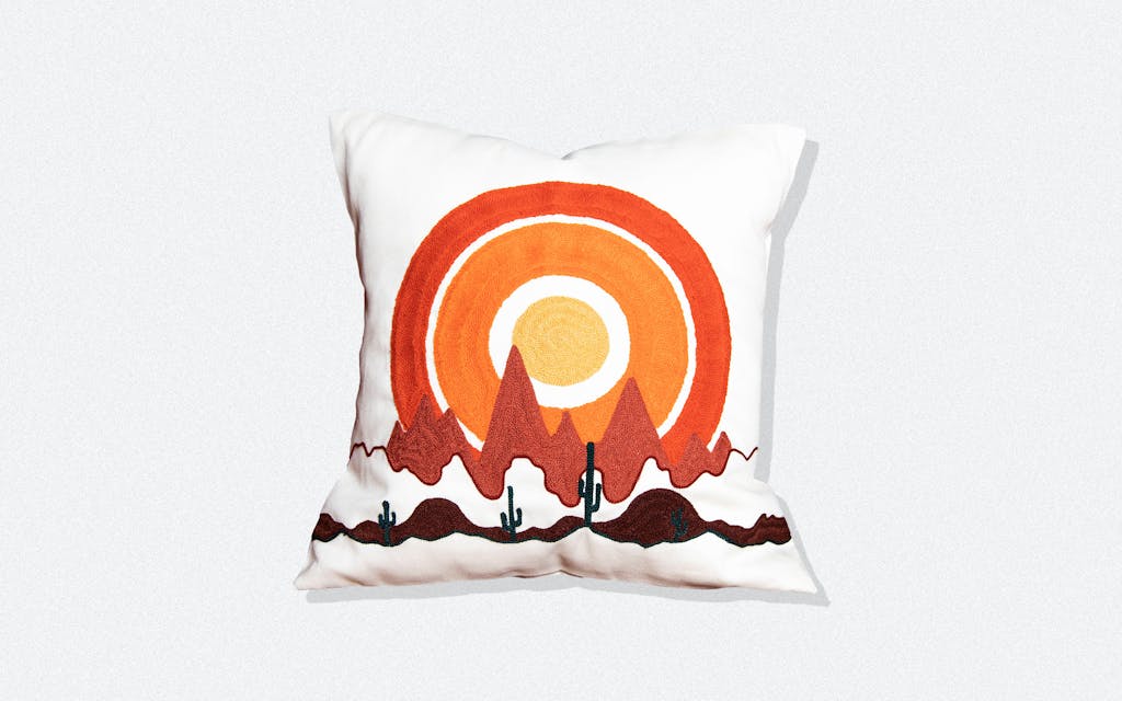 Throw pillow with a 1970s-inspired sun and mountain scene from Circa 1975 in Lockhart.