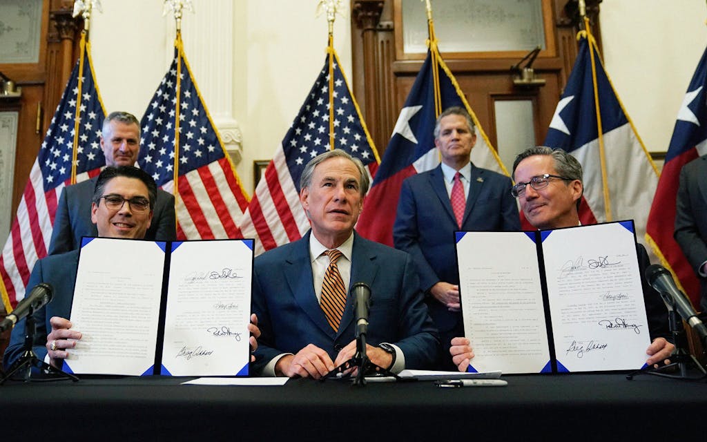 Greg Abbott speaks as two energy related bills he signed are displayed on June 8, 2021 in Austin.