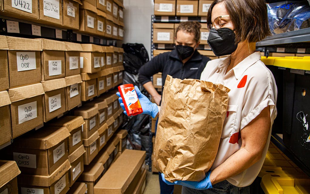 Anthropology Professor Dr. Kate Spradley reviews the personal items of a deceased unidentified migrant stored along with the individual’s unclaimed remains at Texas State University’s Operation Identification lab.