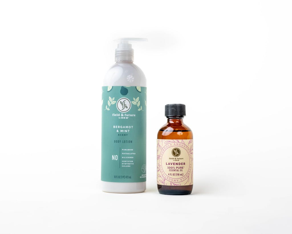 Product photo of H-E-B body lotion and essential oil.