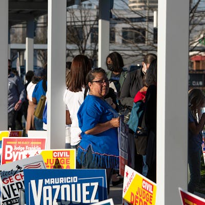 Voters wait in line outside of the Metropolitan Multi-Service Center polling place in Houston on March 1, 2022.