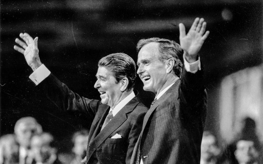 US President Ronald Reagan (left) and Vice President George W. Bush greet applause from the floor of the Dallas Convention Center during the Republican National Convention in Dallas on August 24, 1984.