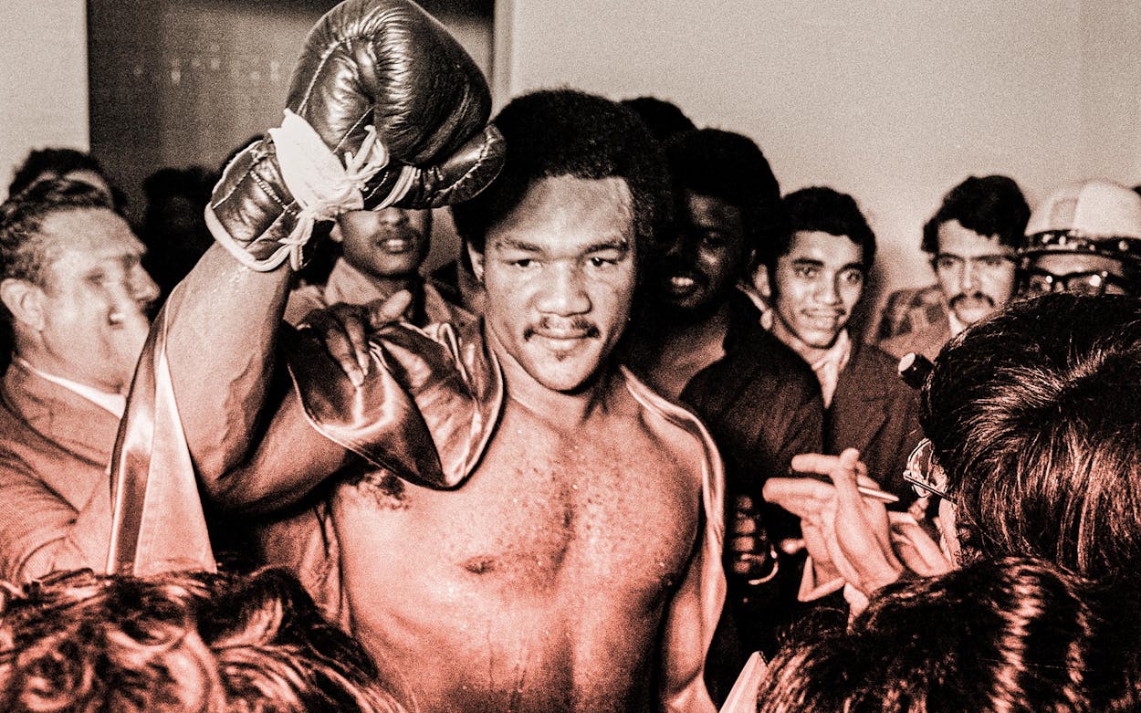 World champion George Foreman on his way to the dressing room after he successfully defended his title, in Caracas, Venezuela, on March 27, 1974.