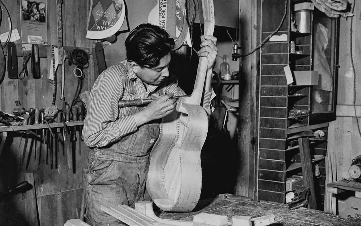 Miguel Acosta working on a guitar at Acosta Music Company.