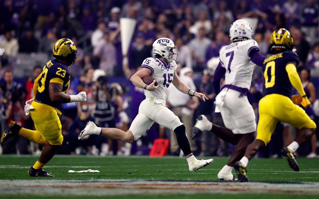 Quarterback Max Duggan #15 of the TCU Horned Frogs runs during the first half of the Vrbo Fiesta Bowl against the Michigan Wolverines at State Farm Stadium on December 31, 2022 in Glendale, Arizona. The Horned Frogs defeated the Wolverines 51-45.