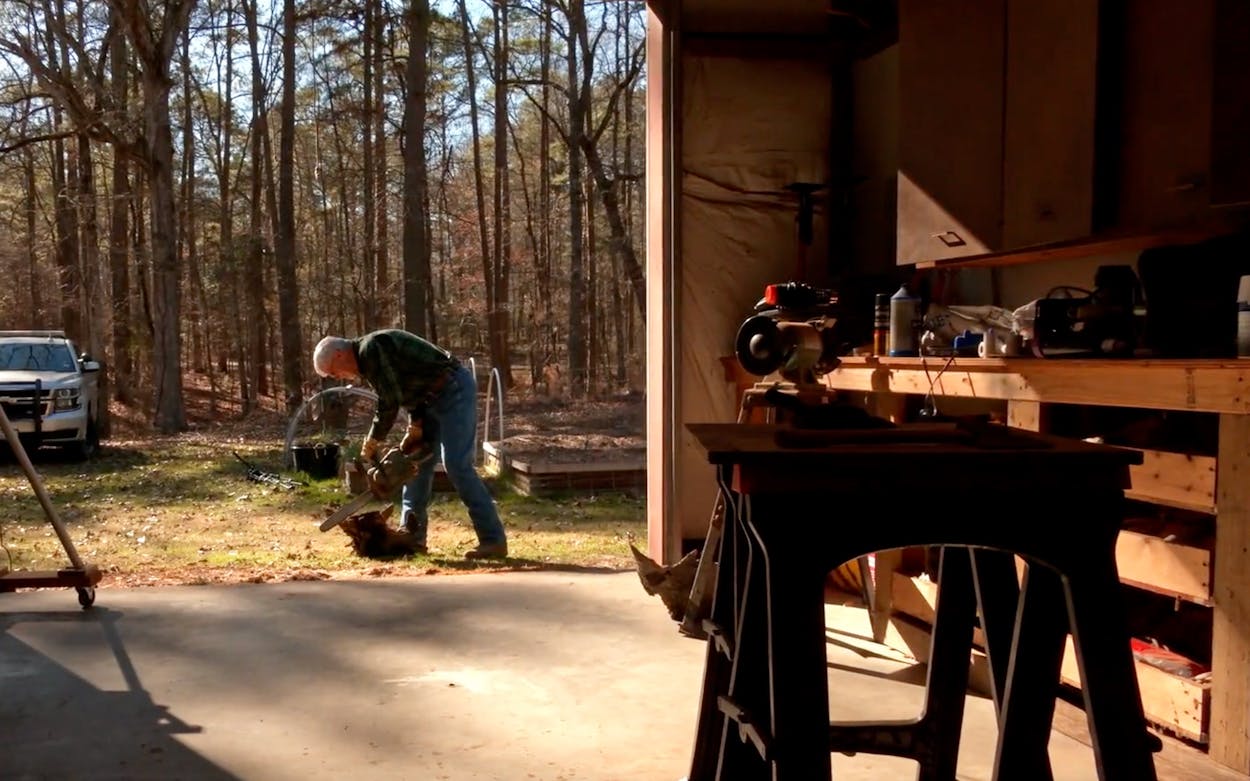 Mike Woody cutting wood at his home.