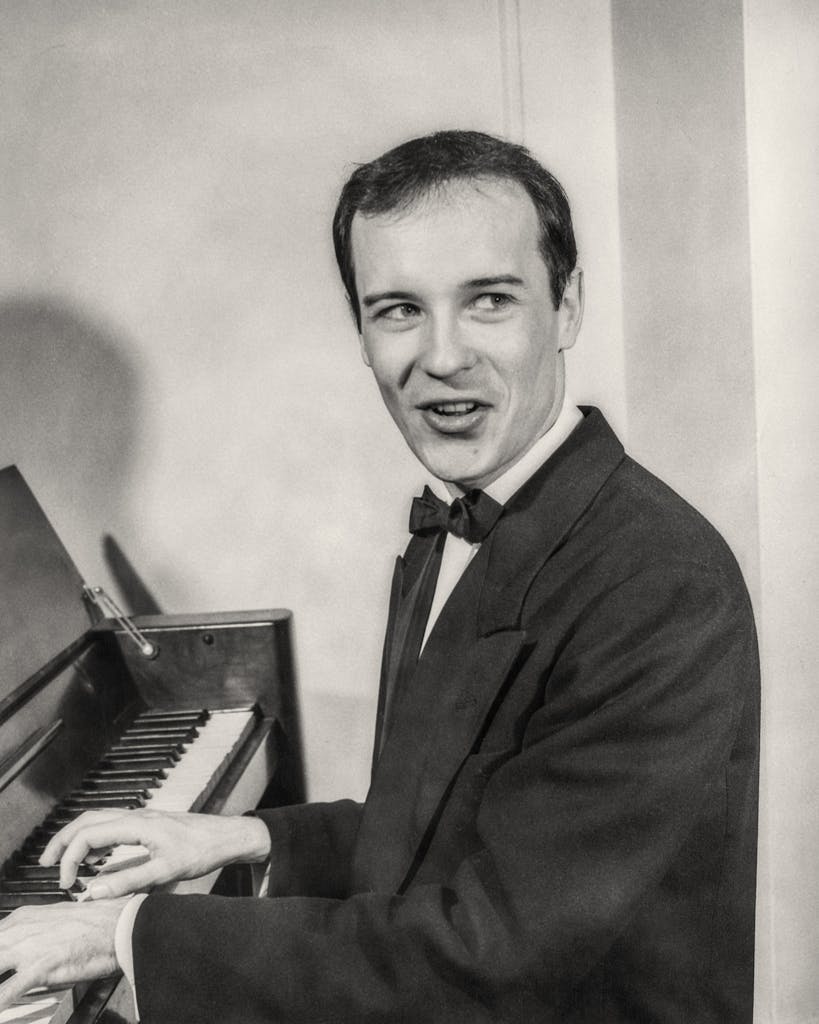 Brown at a piano in 1949.