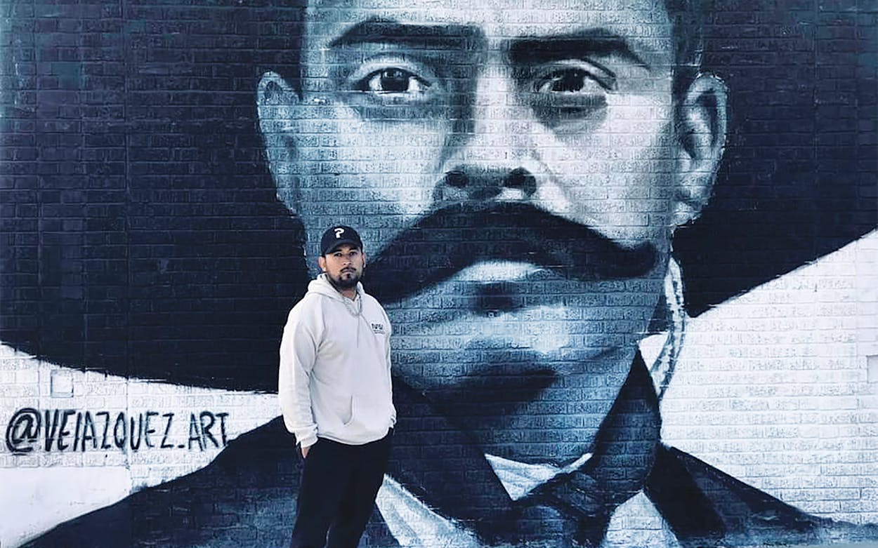 Juan Valezquez in front of his mural of Emiliano Zapata.