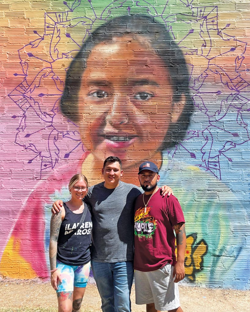 Sarah Ayala, Ryan Ramirez, and Juan Valezquez in front of his mural of ten-year-old Alithia Ramirez in Uvalde.