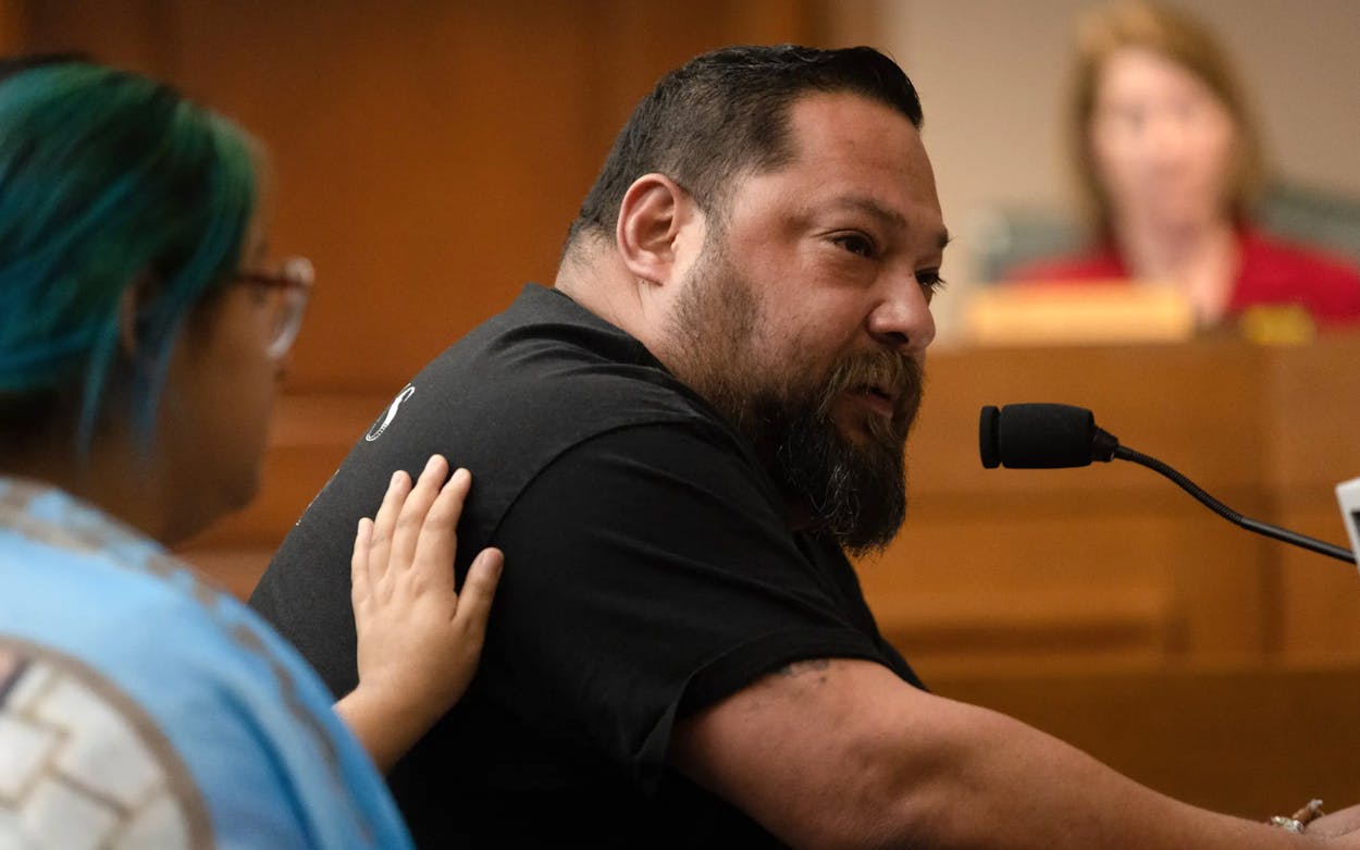 Jasmine Cazares places a hand on her father, Javier, to console him while he speaks through tears, testifying in favor of House Bill 2744 to the Community Safety Committee in the state Capitol in Austin on Tuesday. The bill seeks to raise the age required to purchase semi-automatic rifles from 18 to 21.