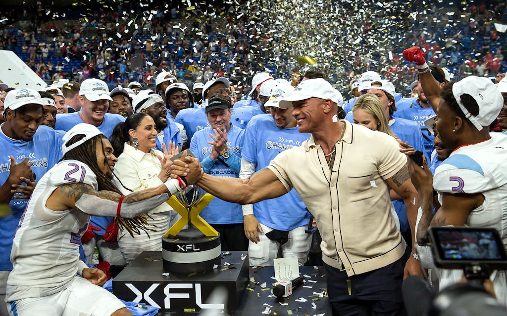 XFL owner Dwayne "The Rock" Johnson celebrates with the Championship winning Arlington Renegades after the inaugural XFL Championship between the D.C. Defenders and the Arlington Renegades at the Alamodome on May 13, 2023 in San Antonio, Texas.
