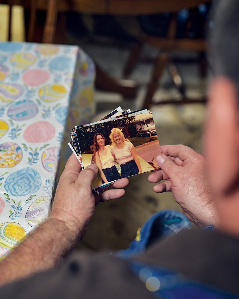Roy Hayes holds a photograph of his late friend Susan Woods and his wife, Cindy Hayes, in his Stephenville home, on May 30, 2023.
