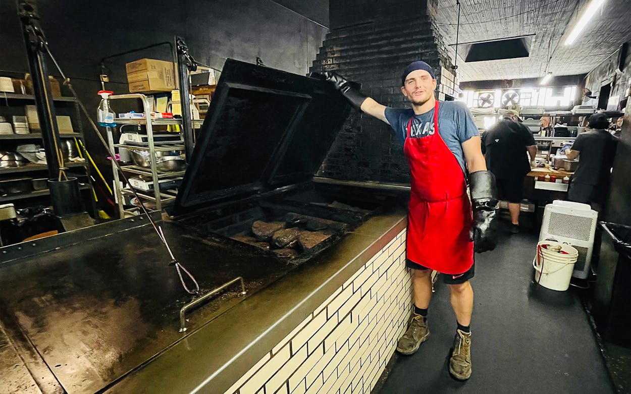 Ethan Alford, 25, who works the pit room at Louie Mueller Barbecue in Taylor, Texas.